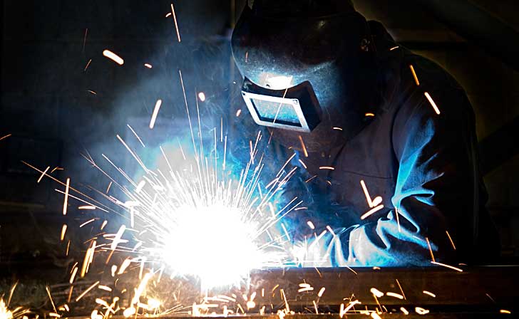 Welder at work with sparks flying